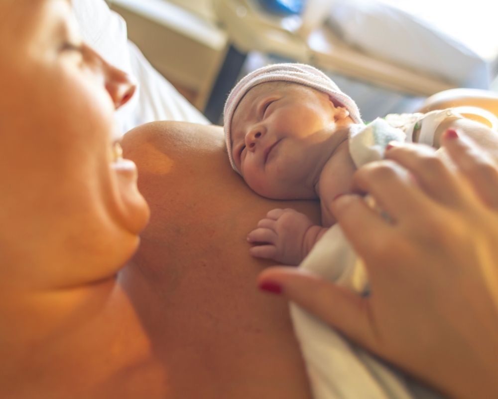 Image of mom holding her newborn after delivery