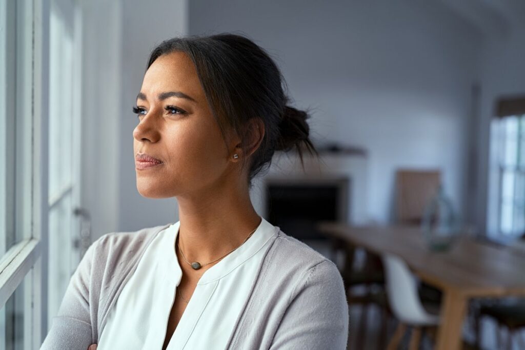 Woman staring out the window, daydreaming.