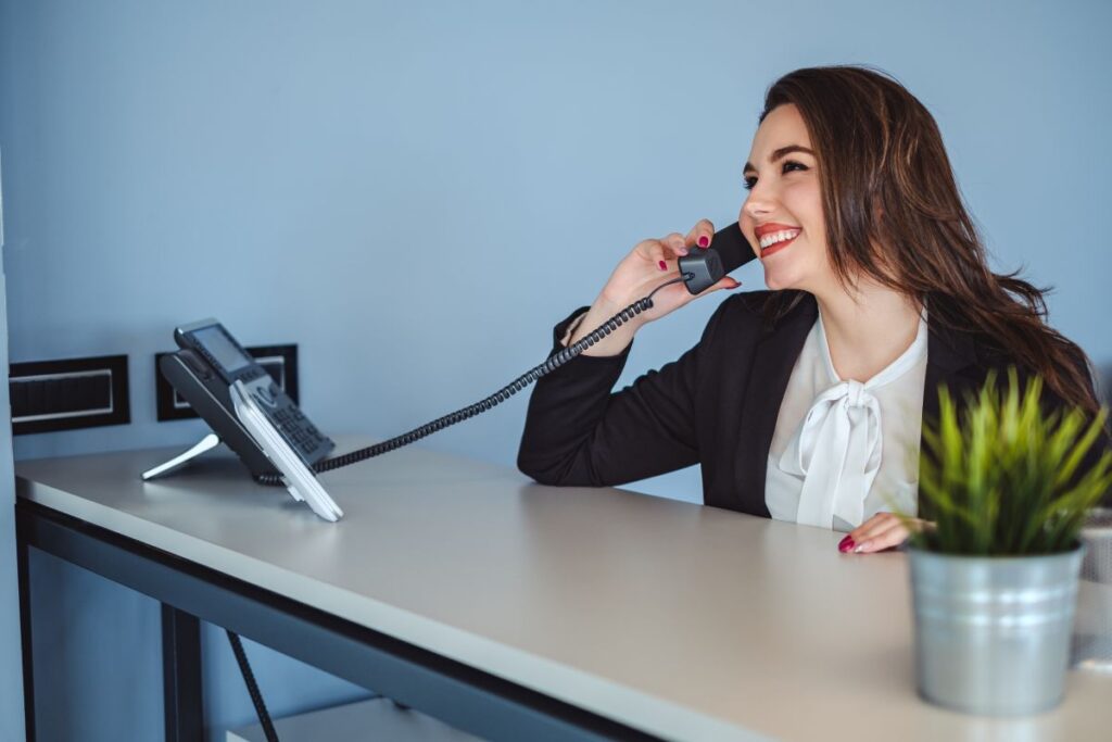 Woman answering phones in an office setting.