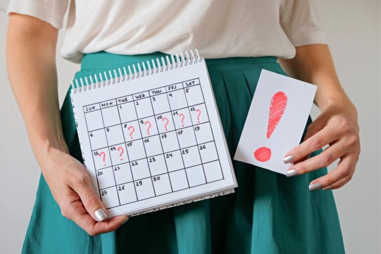 Woman holding calendar with question marks and a sign with an exclamation point